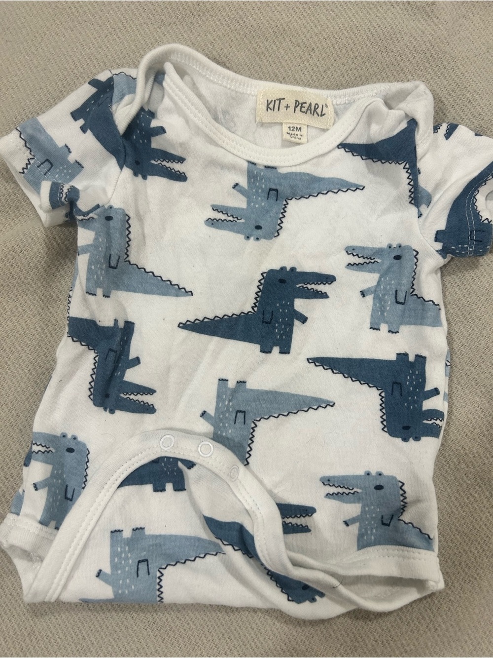 Kit + Pearl White Baby Onesie with Blue Crocodile Print